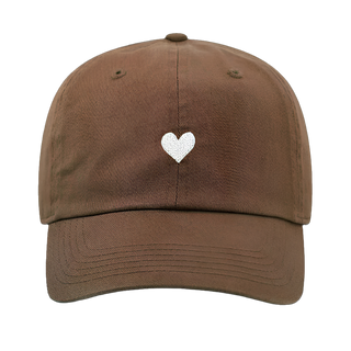 mocha mousse caramel baseball cap with a white heart design on a white background by atticus poetry 